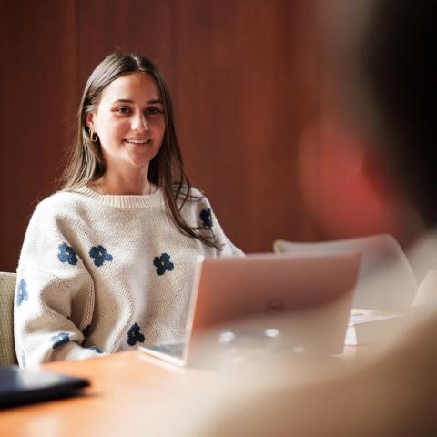 Female law student sitting at desk with laptop